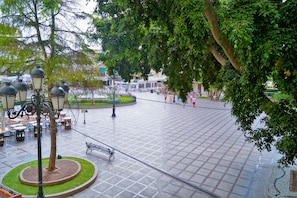A spacious plaza with a central fountain, surrounded by trees and benches. - Torremolinos Hostel (Torremolinos)