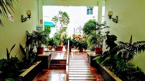 A marble staircase leading to a covered area with potted plants on either side. - Torremolinos Hostel (Torremolinos)