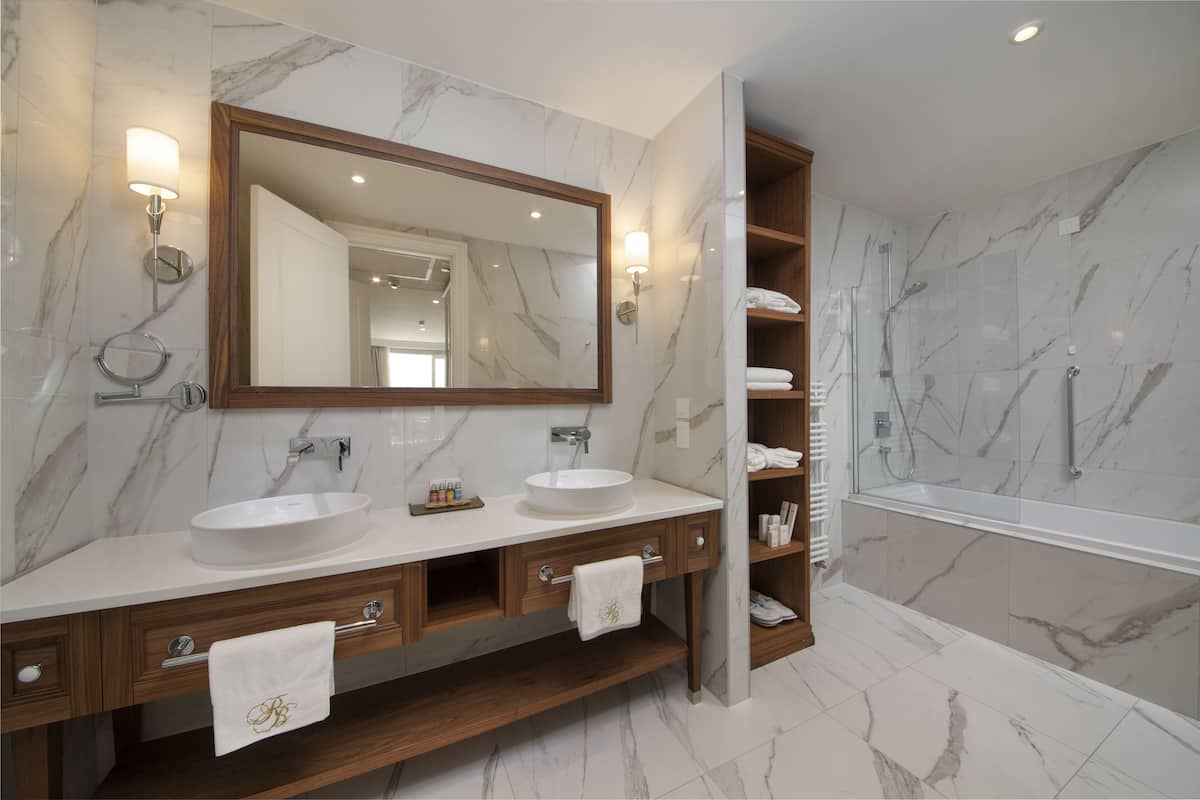 bathtub, designer toiletries, hair dryer, bathrobes