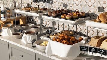 A buffet with various food items and labels.