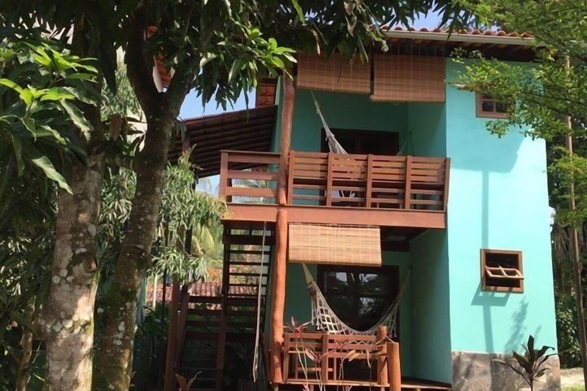 A two-story building with a hammock and wooden deck.