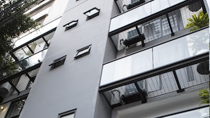 A modern building with multiple balconies, large windows, and a flat facade. - Suites Lerma (Mexico City)