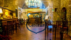 Hotellin sisätilat: kiviseinät, suuri kattokruunu ja kyltti, jossa lukee ”Hotel Castillo”.