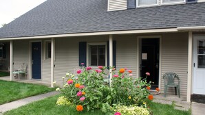 A house with a porch, a door, and a window. - Boyne City Motel (Boyne City)