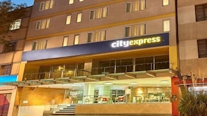 A multi-story hotel with a CityExpress sign at the ground level.