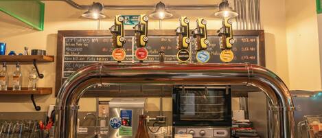 A bar area with a tap system, a beer bottle, and glasses.