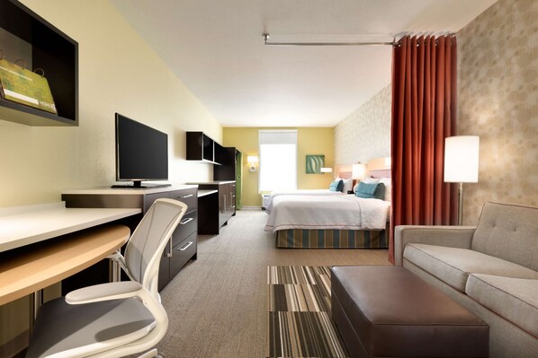 A hotel room with a desk, chair, bed, and a sofa. - Home2 Suites by Hilton Cleveland Independence (Independence)