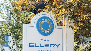 A sign for The Ellery Hotel in Provincetown, featuring a sun emblem and text.