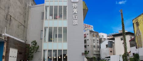 A modern building with large windows and a sign indicating it is a Light Hotel.