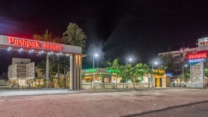 Pushpak Resort with a prominent entrance, a restaurant, and a pool area. - Hotel Pushpak Resort (Rahata)