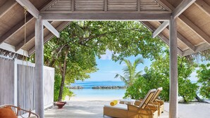 A covered outdoor seating area with a view of the beach and ocean. - NH Maldives Kuda Rah Resort (Kuda Rah)