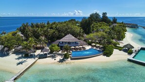 A resort with a swimming pool, beach, and ocean view. - NH Maldives Kuda Rah Resort (Kuda Rah)
