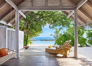 A covered outdoor seating area with a view of the beach and ocean. - NH Maldives Kuda Rah Resort (Kuda Rah)
