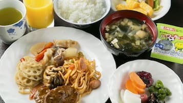 A meal with rice, noodles, soup, and a variety of vegetables.
