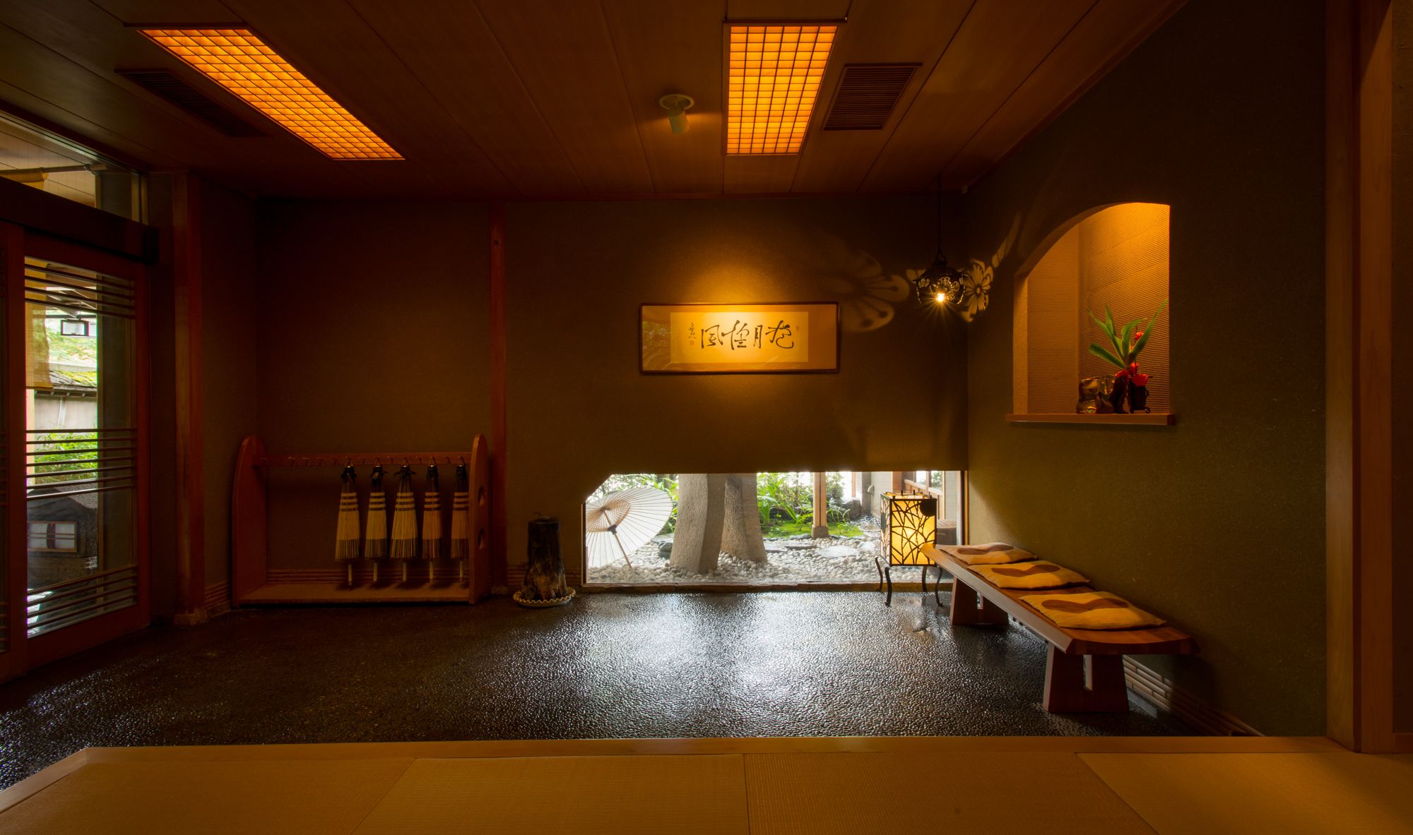 A traditional Japanese room with tatami mats, a shoji screen, and a low wooden bench.