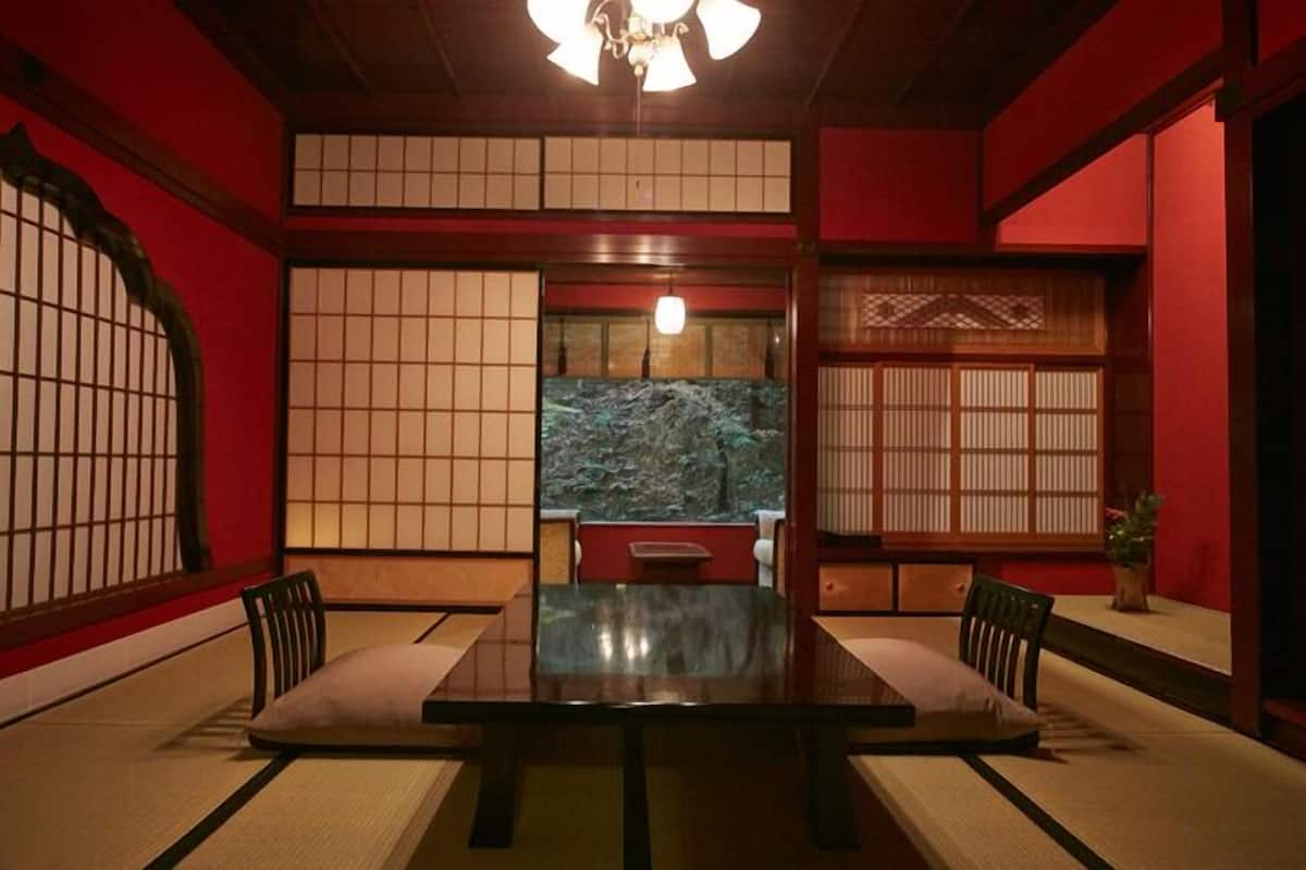 A traditional Japanese room with tatami flooring, a low table, and shoji screens.