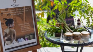 A poster for Angkor Elysium Hotel detailing services like massage therapy, body therapy, facial treatment, and hand and foot care.