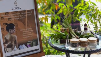 A poster for Angkor Elysium Hotel detailing services like massage therapy, body therapy, facial treatment, and hand and foot care.