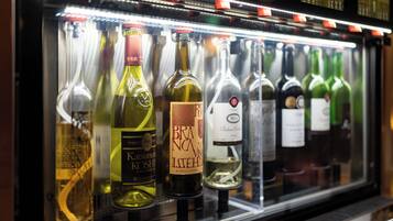 A refrigerated display case containing various bottles of wine.