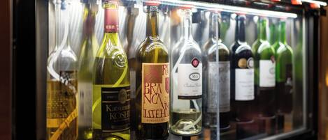 A refrigerated display case containing various bottles of wine.