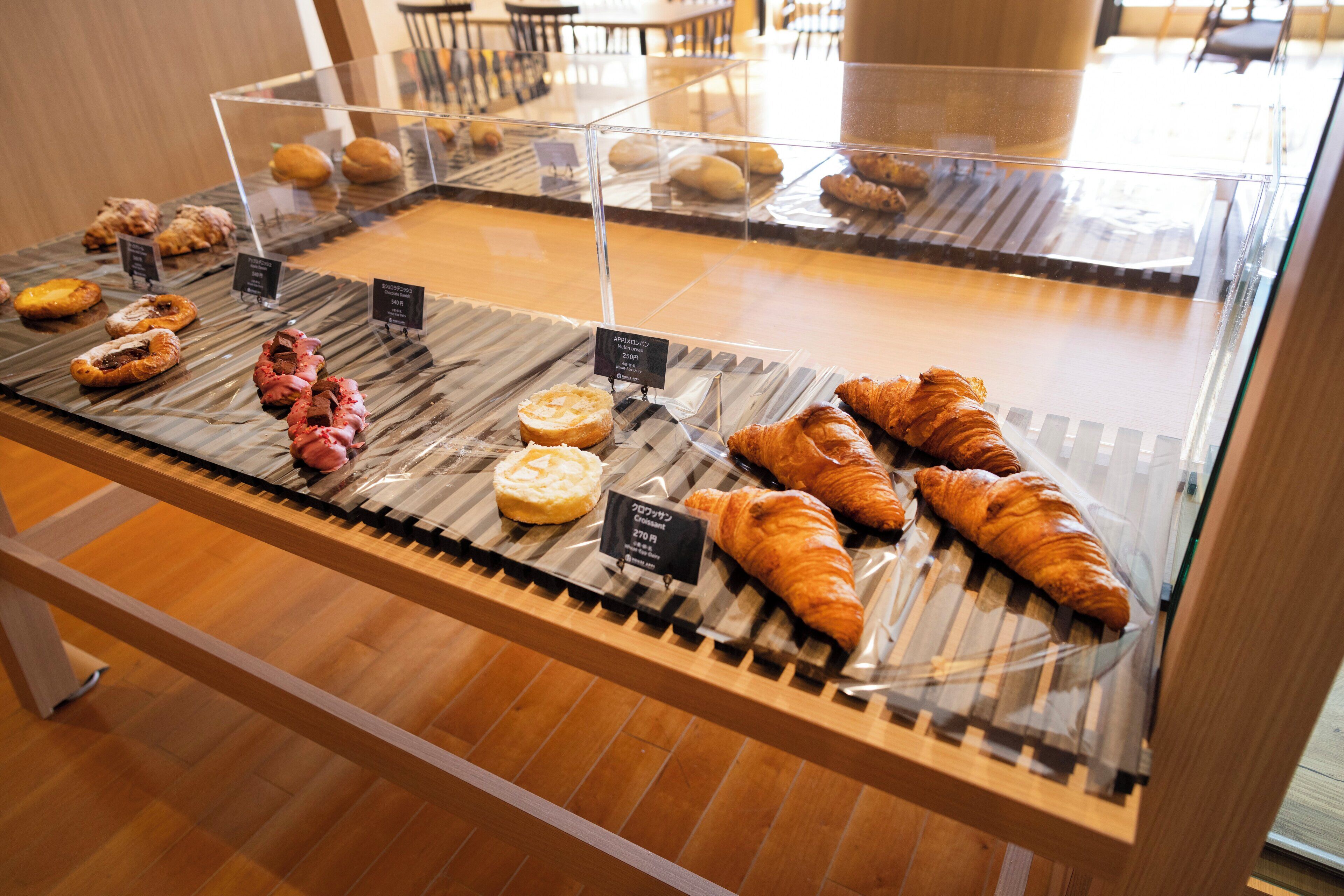 A bakery display with various pastries and baked goods.