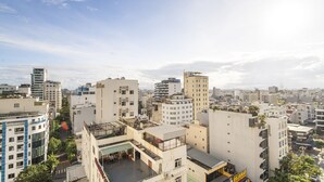 A cityscape with various buildings, including a hotel with a rooftop terrace. - May Beach Hotel (Da Nang)