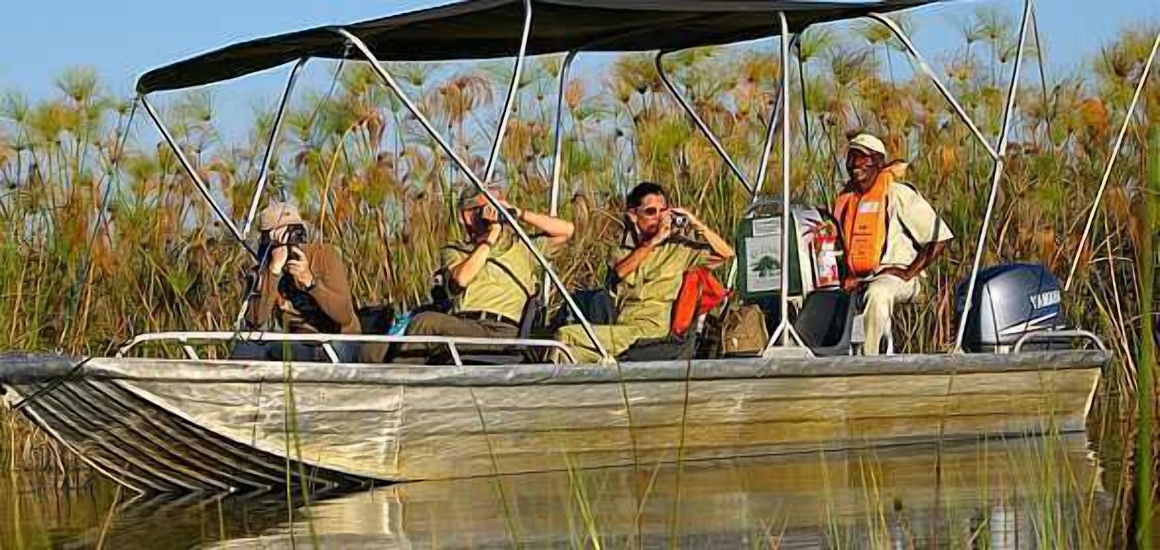 A boat with four people, one of whom is taking a photo.