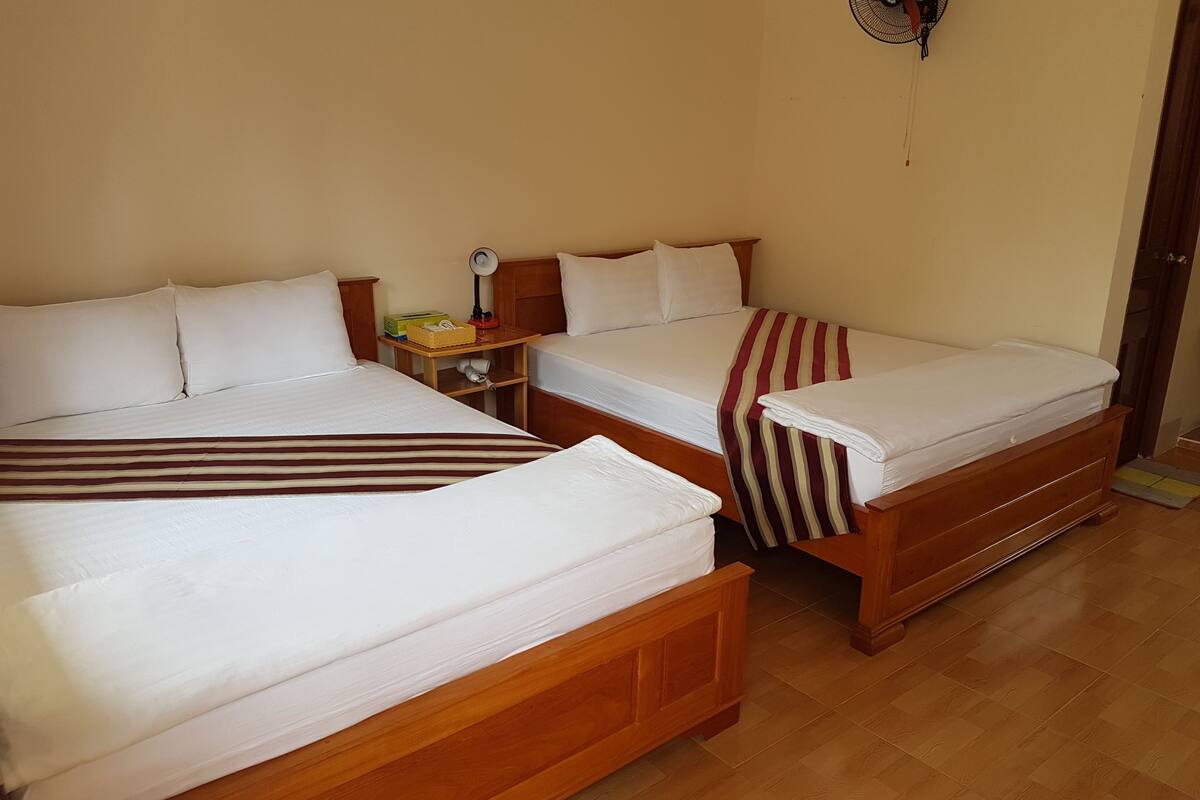 deluxe quadruple room, 2 queen beds, non smoking, garden view | minibar, in-room safe, individually furnished, free wifi