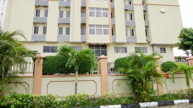 A multi-story hotel with a beige facade, balconies, and a sign reading "Le Real Hotel & Events Centre". - Le Real Hotel (Lekki)