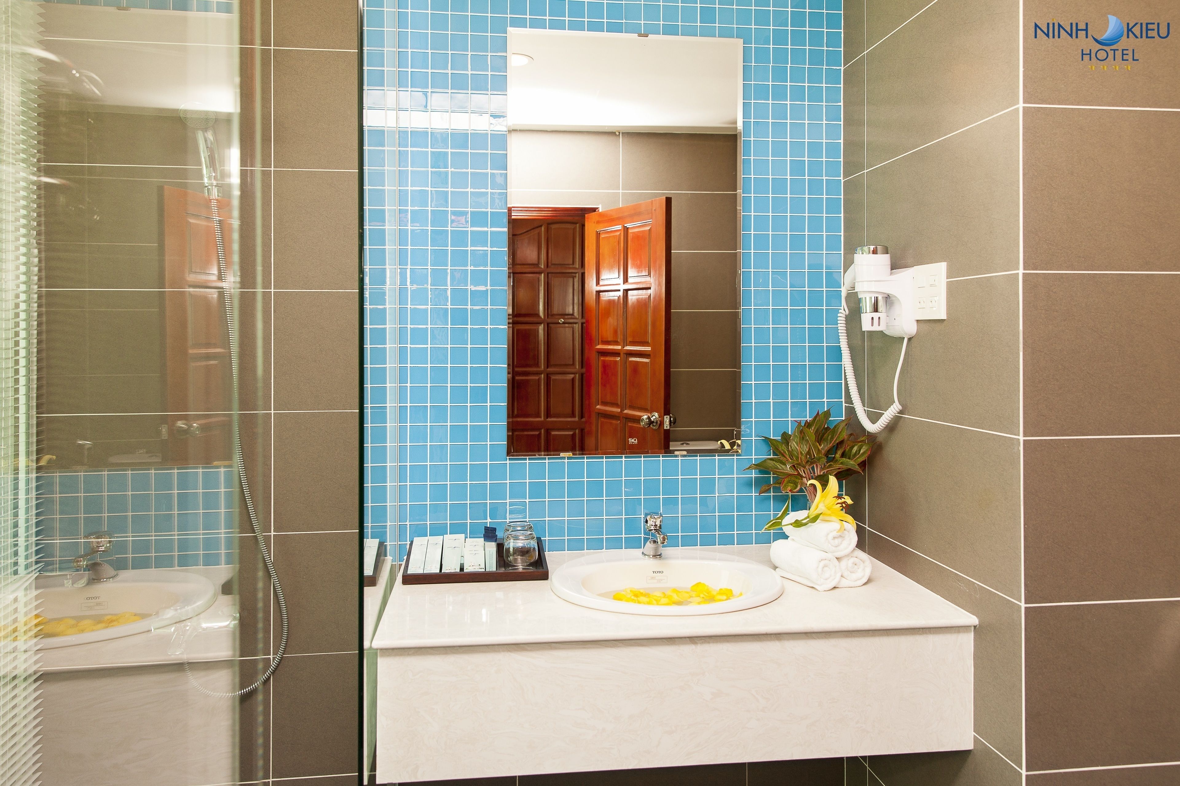 designer toiletries, hair dryer, bathrobes, slippers