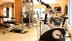 A gym with cardio machines, weightlifting equipment, and a bench. - Rockview Hotel Festac (Lagos)