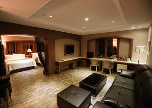A hotel room with a bed, a sofa, a desk, a TV, and a small kitchen area. - Bucheon Hotel (Bucheon)