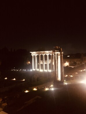 A classical building with illuminated columns at night.