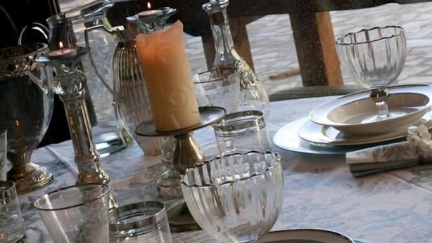 A table set for dining outdoors with candles, glassware, and plates. - Bisalde Agroturismo (Bakio)