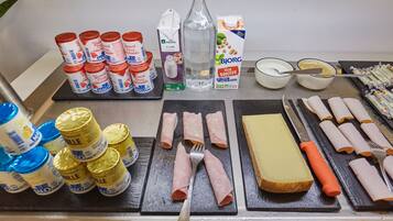 Una mesa de desayuno con diversos alimentos y condimentos.