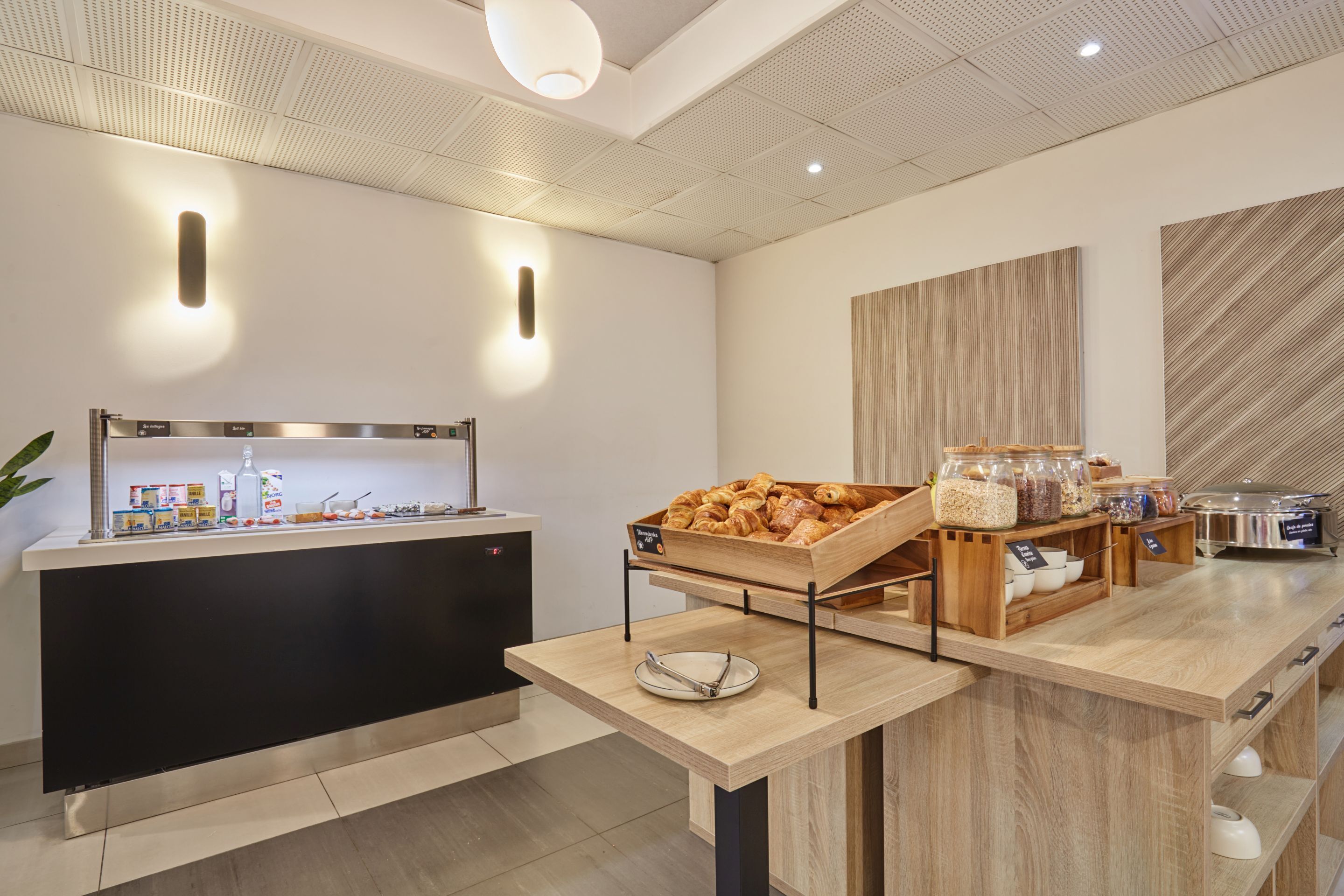 A modern breakfast bar with a variety of food items and a coffee station.