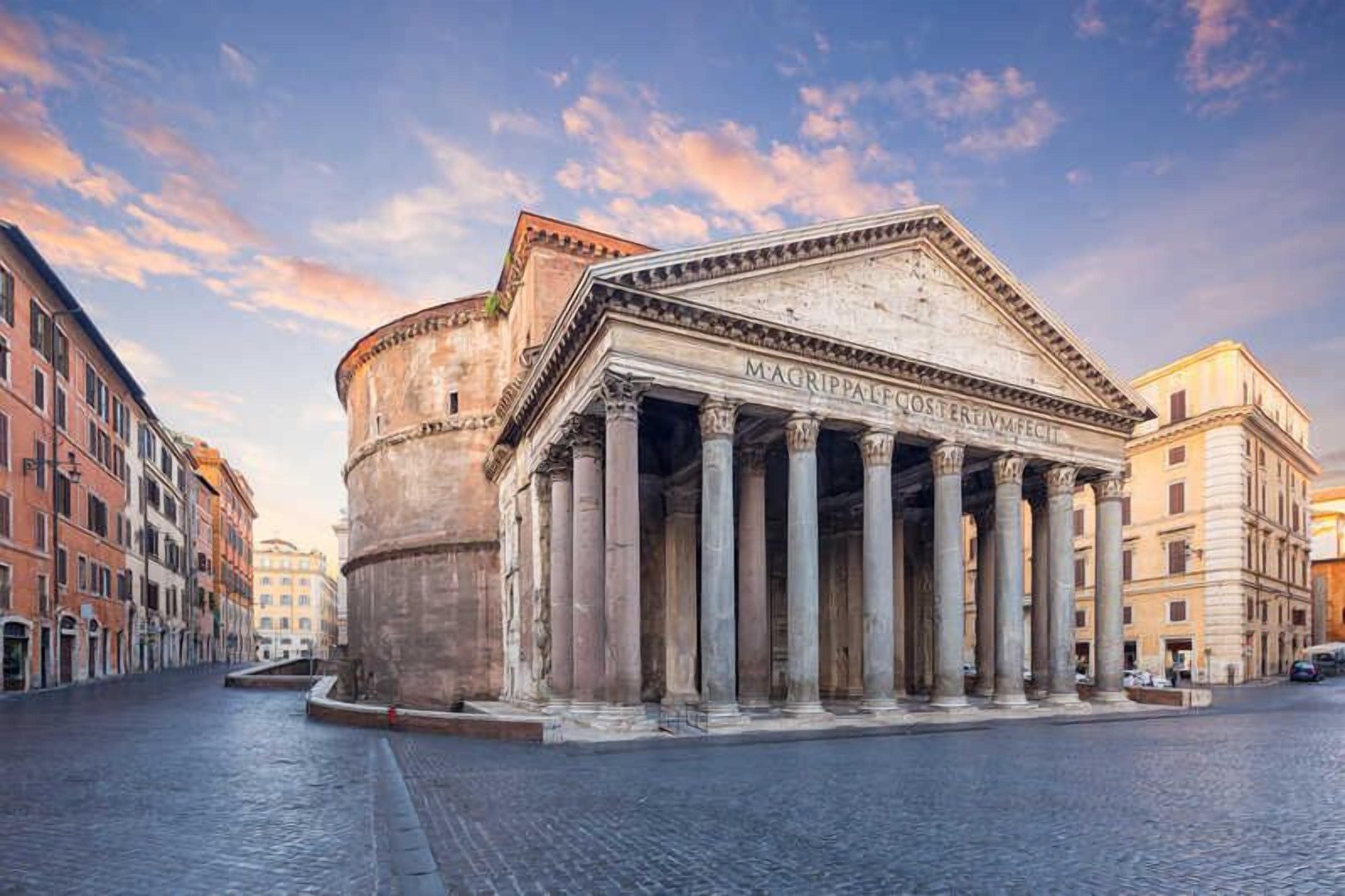 A classical building with columns and inscriptions, surrounded by historic buildings.