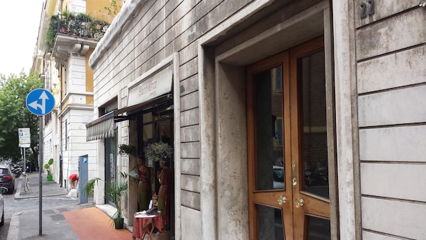 A building with a large wooden door and a sign above the entrance. - Vatican Relais Rome (Rome)