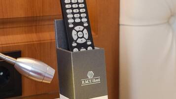 A remote control in a hotel room's charging station.