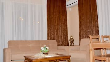 Economy Condo, 1 Double Bed | Living area | 32-inch LCD TV with satellite channels, TV