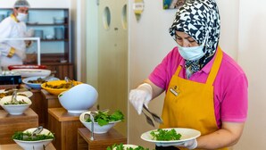 A buffet setup with various dishes and a person serving food. - Diamond Hotel (Amasra)