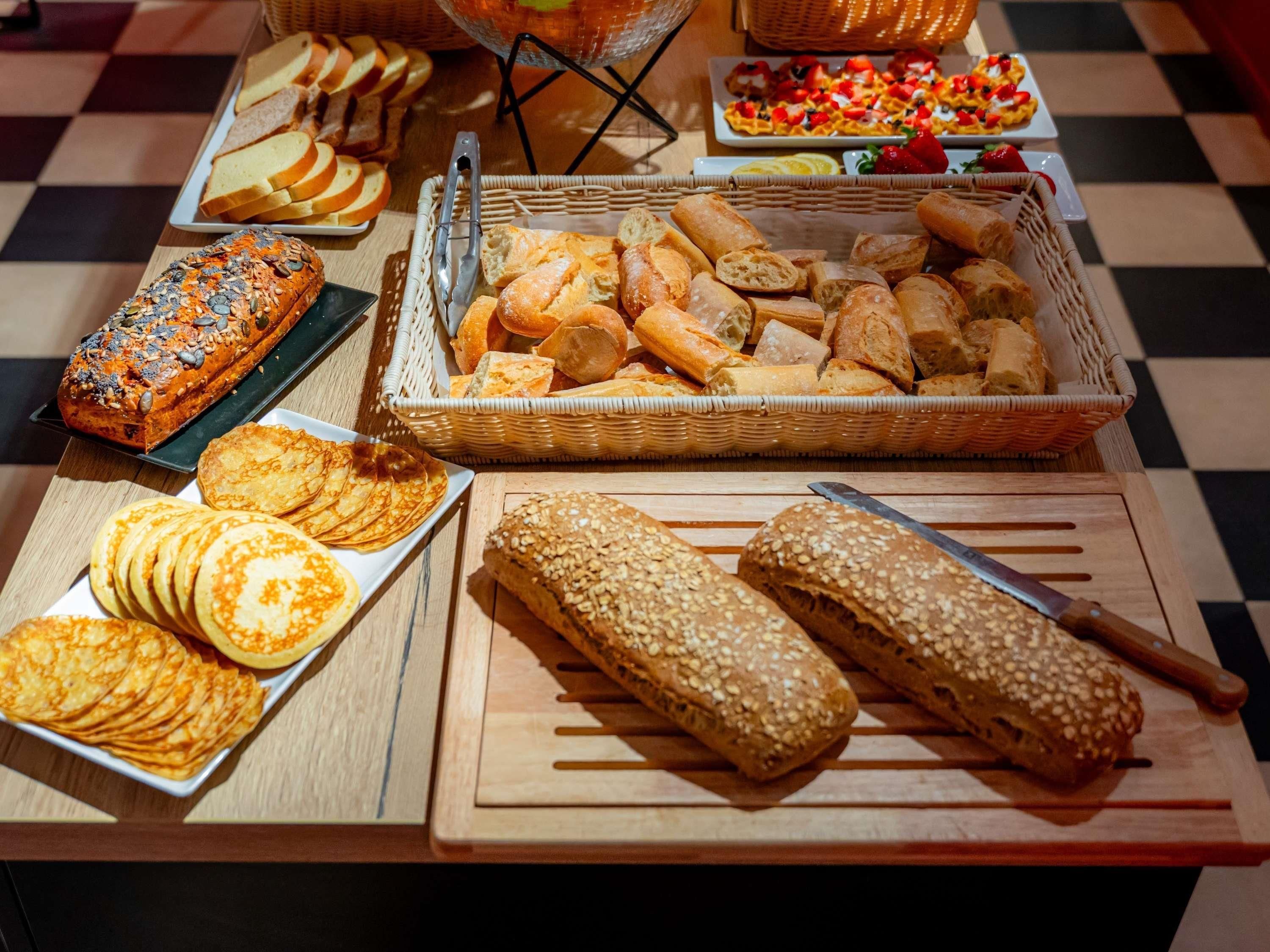 A variety of breads and pastries on a table.