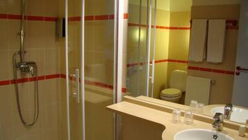A modern bathroom with a glass-enclosed shower, a sink with a mirror, and a toilet.