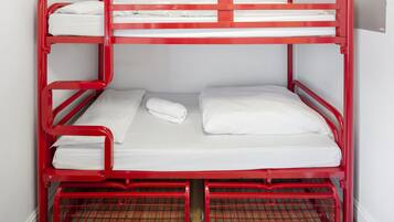 A red bunk bed with white bedding and a metal frame.