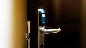A modern door handle with a digital lock and a keyhole. - Winzelle Suites (Zamboanga)