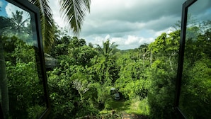 A lush garden with a stone pathway leading through dense foliage. - Bucu Beji Ubud (Ubud)