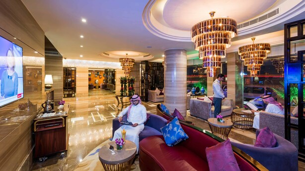 A modern lobby with seating areas, a reception desk, and a large chandelier. - Boudl Gaber (Riyadh)