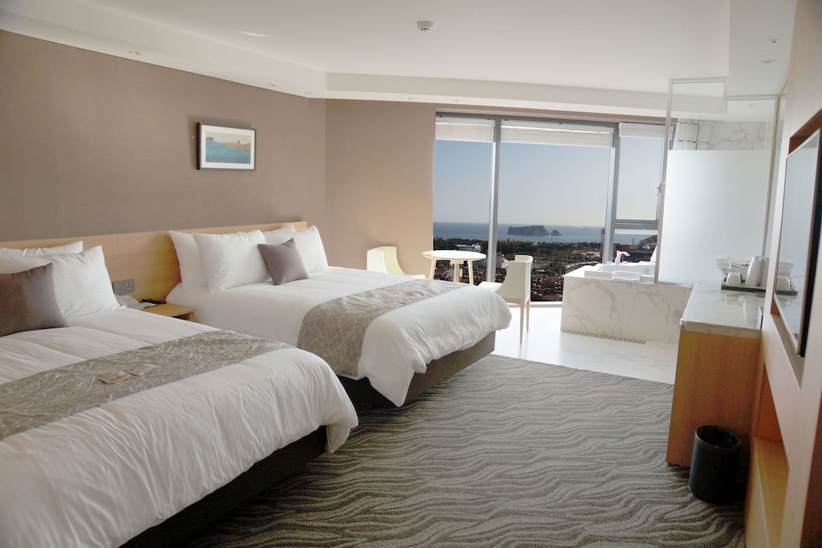 junior suite, 2 double beds, sea view | 1 bedroom, in-room safe, bed sheets