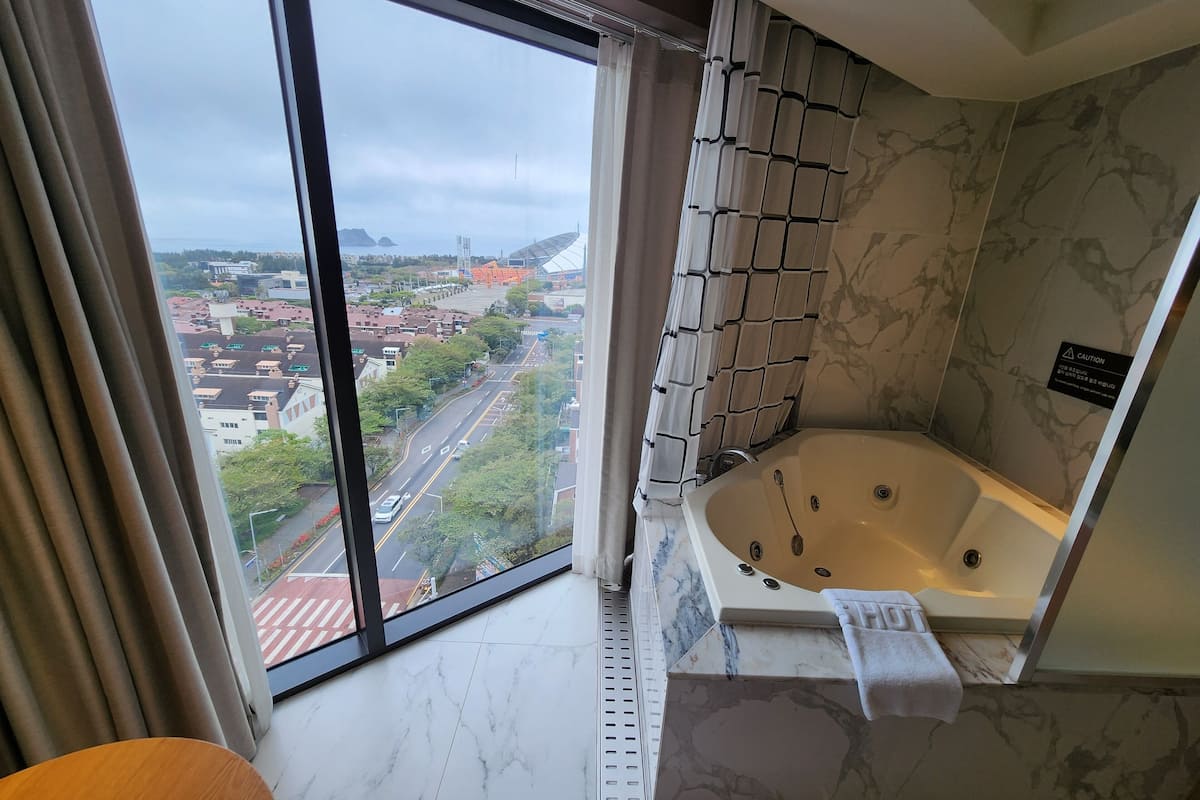 junior suite, 2 double beds, sea view | 1 bedroom, in-room safe, bed sheets