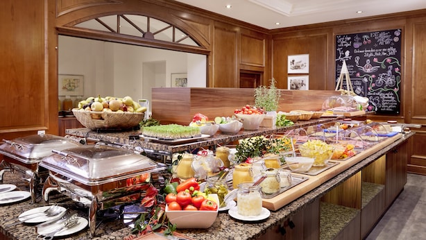 A buffet with various food items and utensils. - Das Alpenhaus Gasteinertal (Bad Hofgastein)
